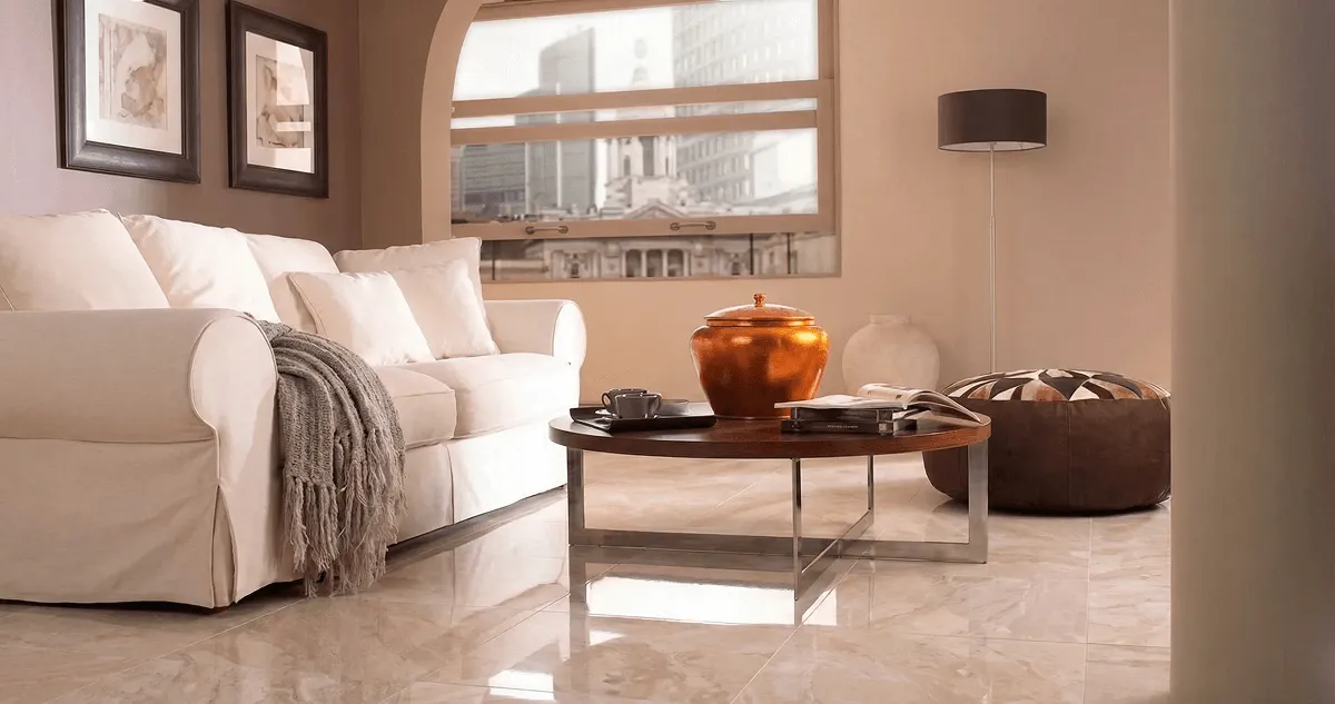 Modern living room with professionally installed marble flooring, a beige sofa, coffee table in Manchester, NH